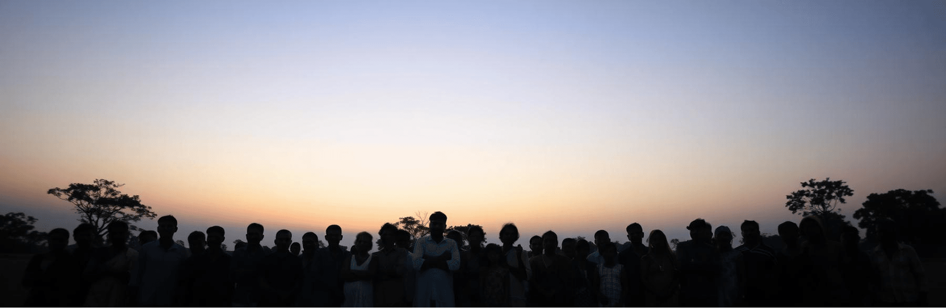 Villagers standing together at dusk